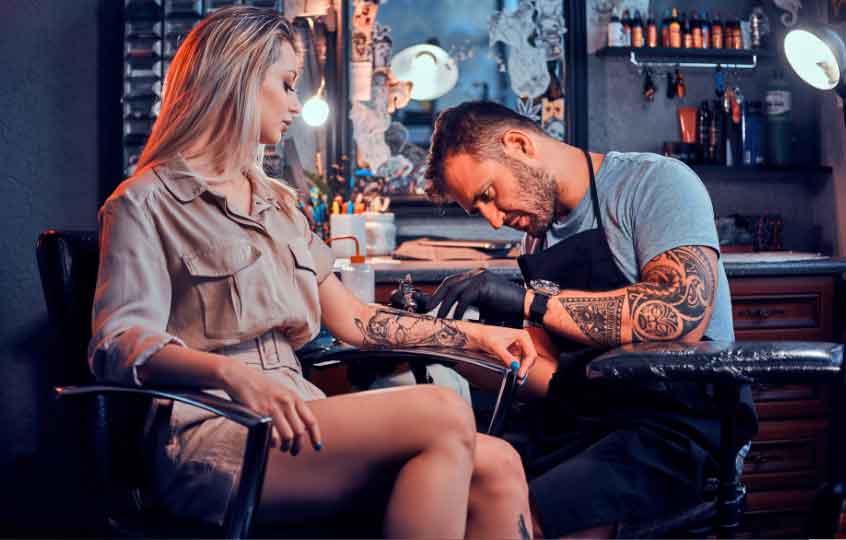 Attractive Blonde Woman Getting a Tattoo