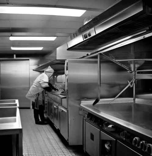 Person cleaning a commercial kitchen for reality TV show